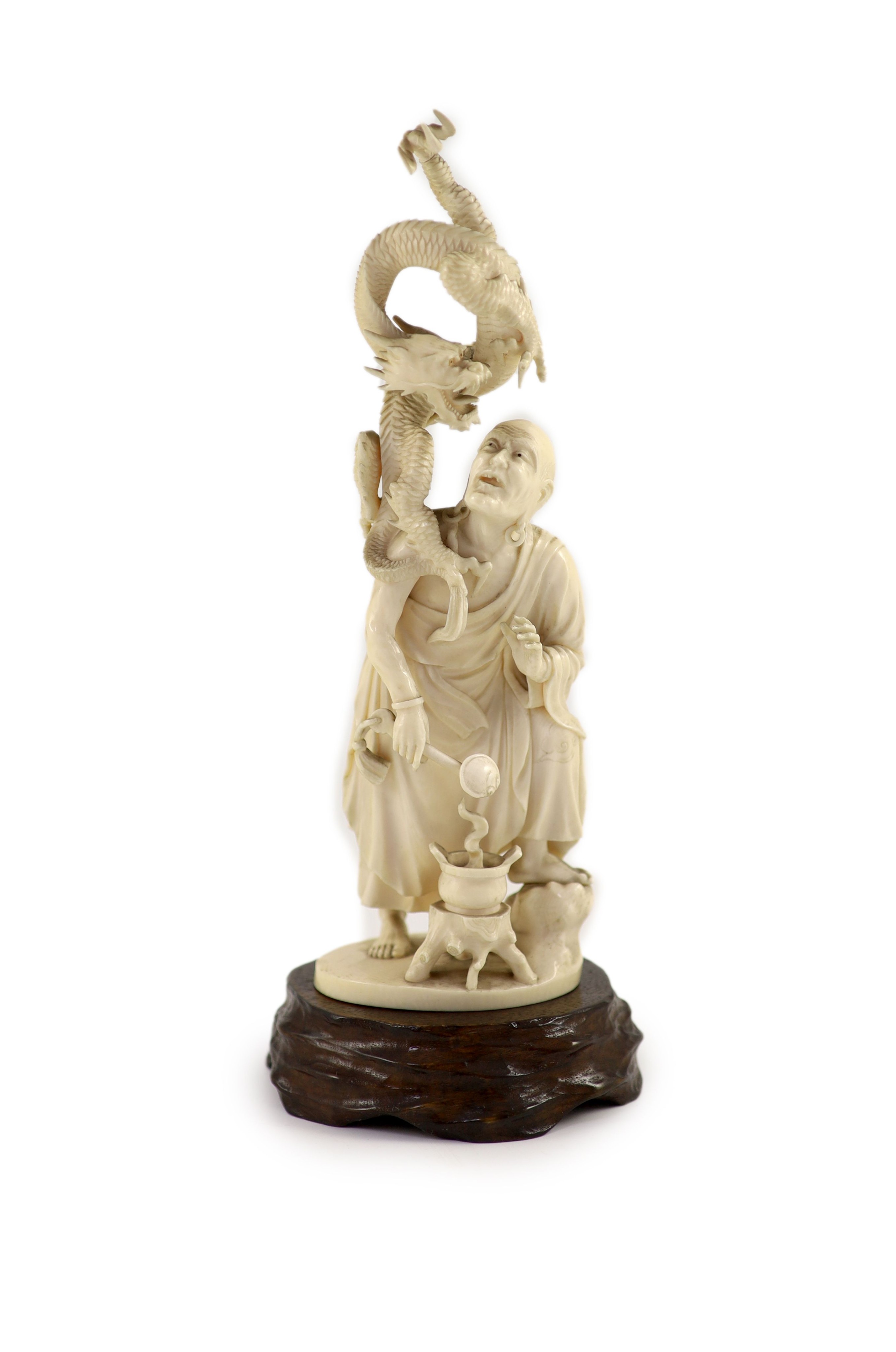 A Japanese ivory okimono of Handaka Sonja, Meiji period, signed Shozan, 22.5 cm high, wood stand